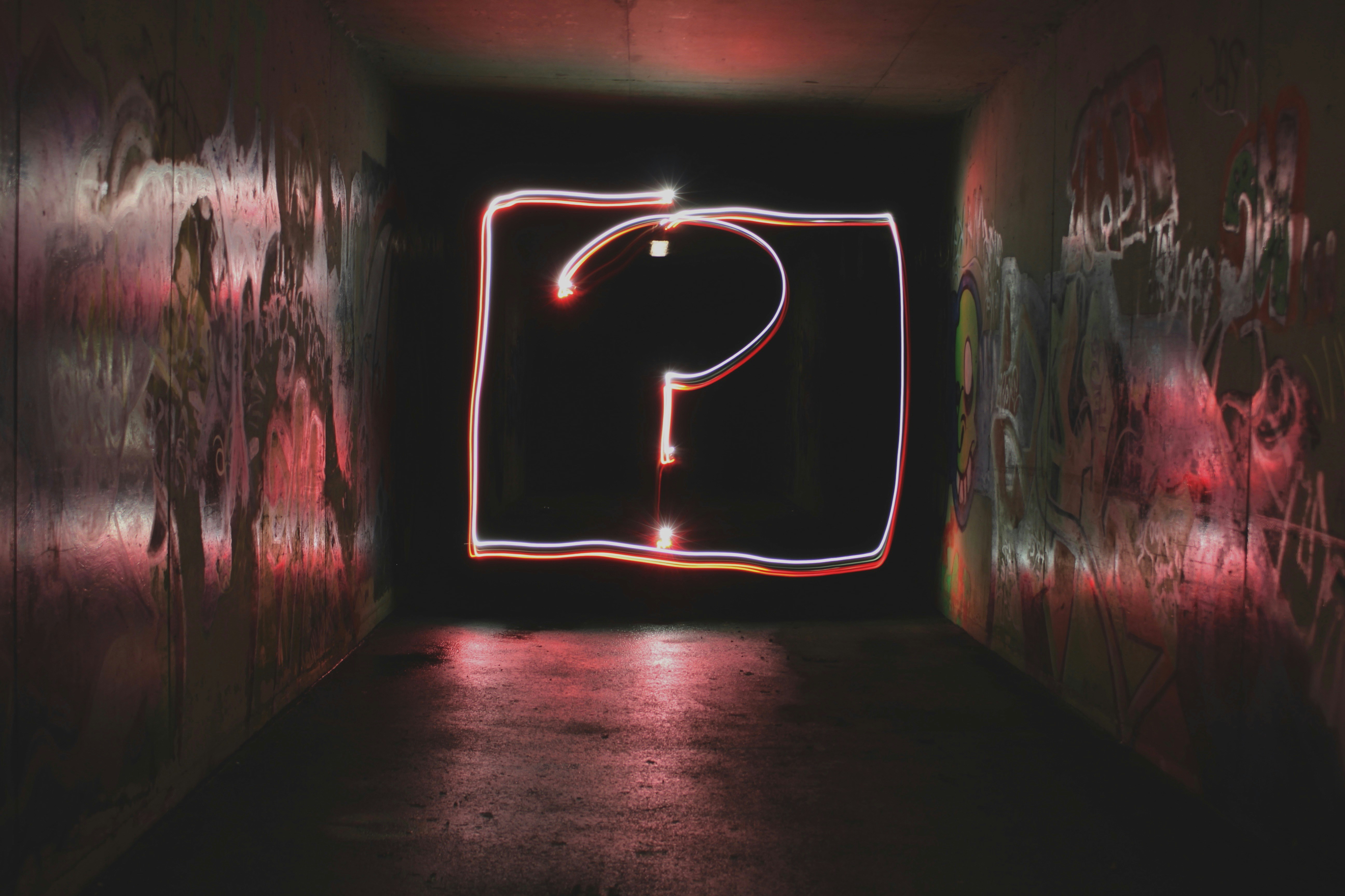 Light painting in the shape of a question mark in a tunnel